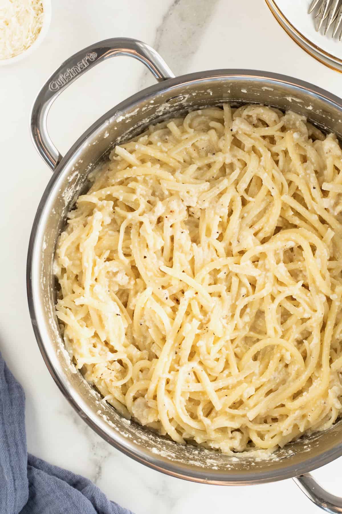 A large stainless steel pot of cacio e Pepe.
