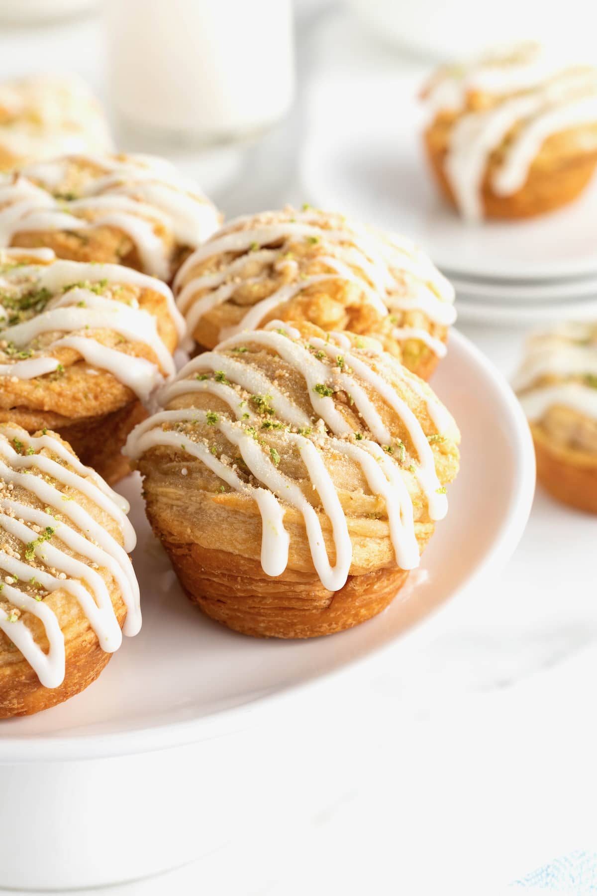 5 key lime cruffins arranged on a large white round serving platter.